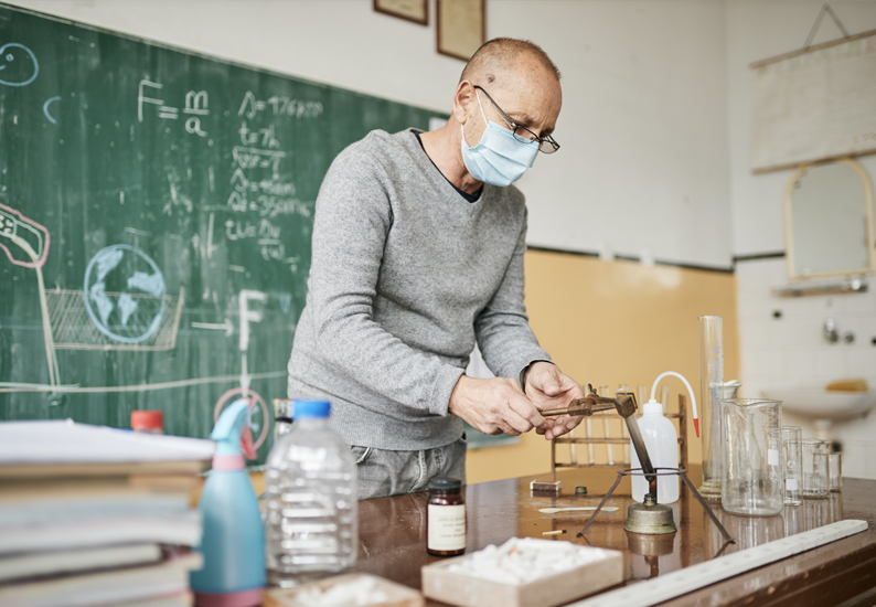 A science teacher prepares an experiment in his classroom.